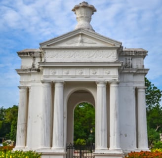 A structure with white paint and greenery around