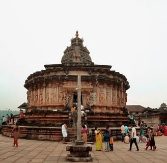 A ancient temple with people walking in front of the temple