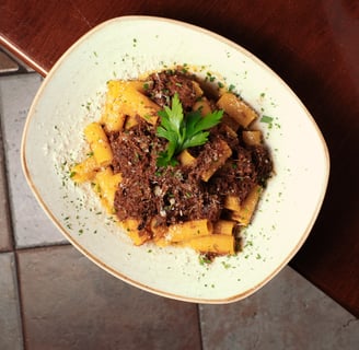 a bowl of pasta with meat and vegetables