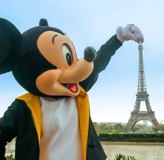 Mickey Mouse standing beside the Eiffel Tower near Disneyland Paris