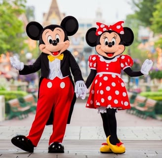 Mickey and Minnie Mouse standing holding hands at Walt Disney World in Florida