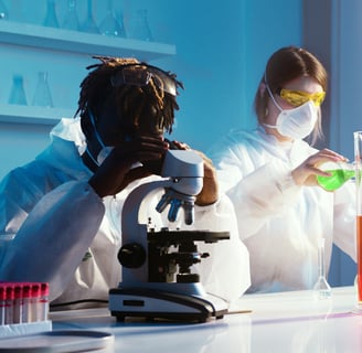 a woman in a lab coat and a microscope