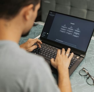 a man sitting on a couch with a laptop computer