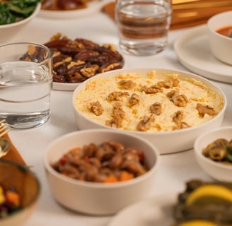 a table with bowls of food and drinks