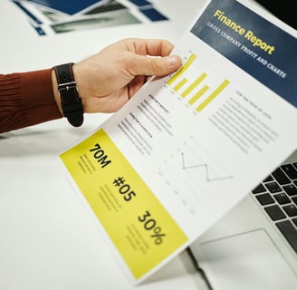 a person holding a piece of paper with a business card