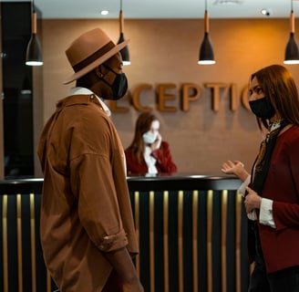 a man and woman in masks and masks on a reception table