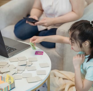 a woman sitting on a couch with a laptop and a laptop