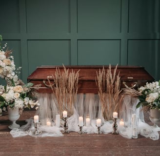 a funeral service with candles and flowers