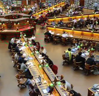 a large room with a lot of people sitting at tables