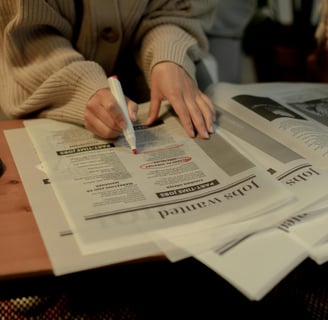 a person sitting at a table with a pen and a pen