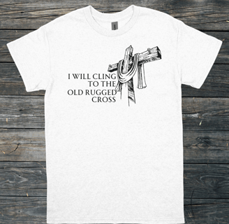 t-shirt mockup on a gray wood floor with the words I will cling to the old rugged cross on the front