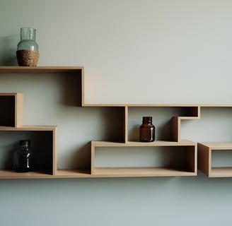 Asymmetrical shelves with a vase on it