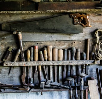 a bunch of woodworking tools on a wall