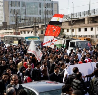 a large group of people standing in a city street, Egypt