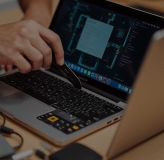 a person is using a laptop computer and a pen