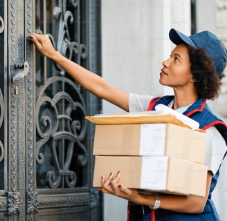 a woman in a blue uniform is holding a box with a box of boxes