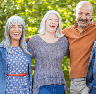 two middle aged women and a man linking arms