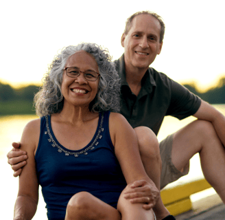 a smiling, middle aged couple