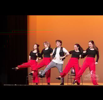 a group of teens tap dancing on a stage
