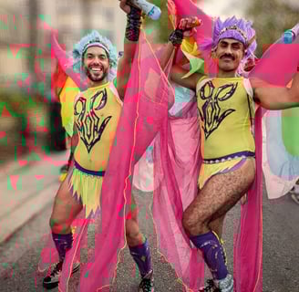 two men in colorful costumes are dancing in the street