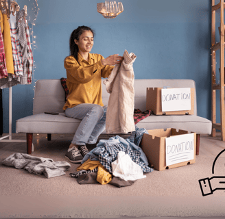 A woman sorting clothes for donation into labeled boxes in a cozy room, promoting sustainability
