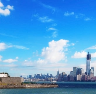 a statue of liberty in front of NYC skyline