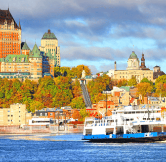 a boat in the water overlooking the Quebec City, Canada skyline
