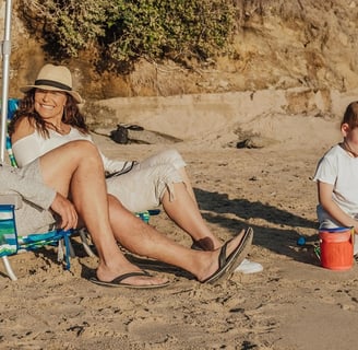 Older couple on beach with grandkids