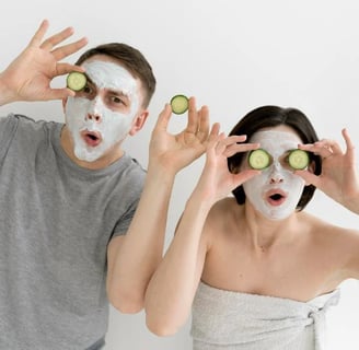 a man and woman with cucumbers on their faces