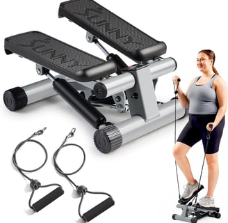 a woman standing on a stationary stepper