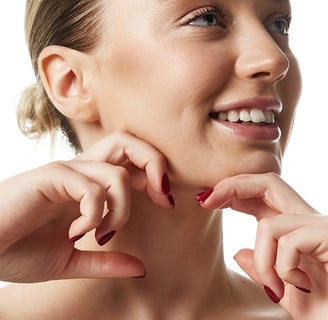 Woman smiling and cupping her chin, indicating satisfaction with facial contour.