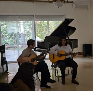 a man and woman playing guitar and guitar together