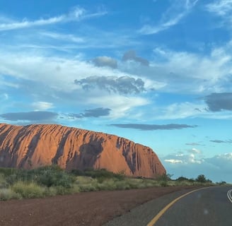 a road with a road sign and a road sign