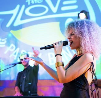 Wedding singer performing live with The Gloves logo in the background