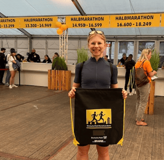 a woman holding a sign that says,'i am a runner