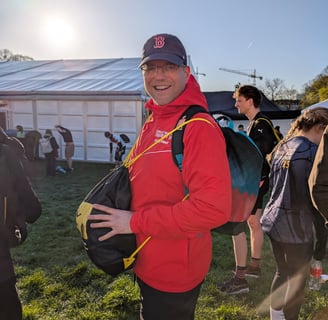 a man in a red jacket and a backpacker