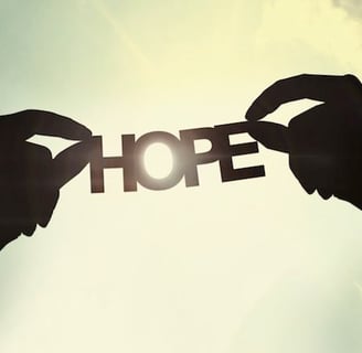 two hands holding up a piece of paper with the word hope written on it