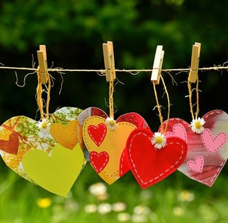 a bunch of hearts on clothes pegs on a clothes line