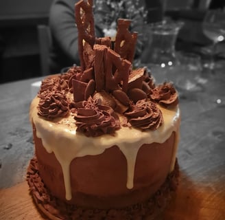 a cake with chocolate icing and chocolate bars on it