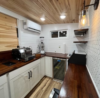 espresso and grinder setup inside custom mobile coffee trailer