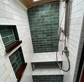 creative and custom tiled shower inside schoolie bus