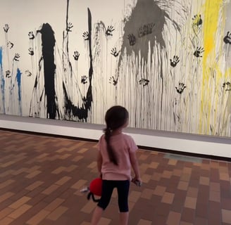 a young girl is walking through a museum