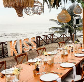 wedding reception set up with a light up sign that says "kiss"