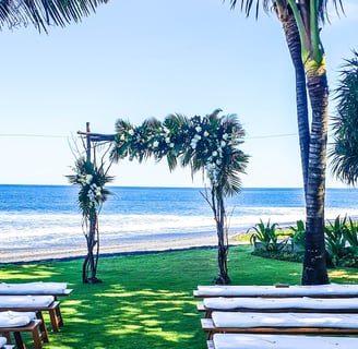 a beach wedding ceremony with a view of the ocean