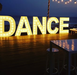 A light up sign that says "dance"