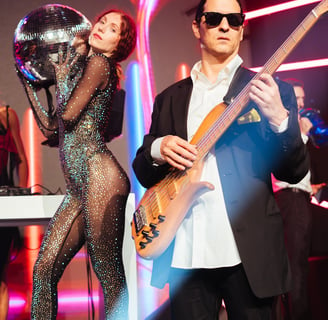 a man and woman in a bodysuits and sunglasses