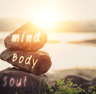 a rock stack of rocks with the words mind body soul soul