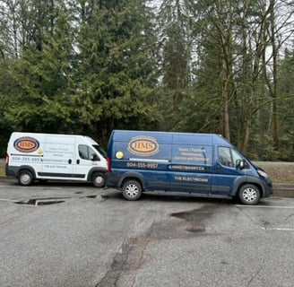 two renovation service vans parked in a parking lot