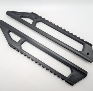 a pair of black plastic pegs on a white background