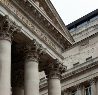 a building with columns and a clock on the outside